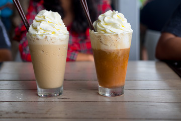 Two drink with wipped cream on top