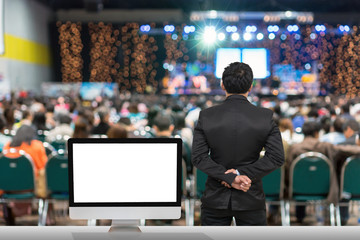Fototapeta Businessman giving the knowledge with showing the white background on the computer screen over blurred photo of attendee in Exhibition Center,Business Seminar concept obraz