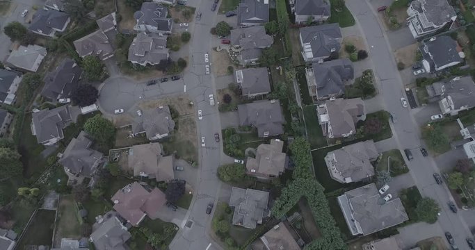 An aerial 4k D-Log footage of streets, cars and houses