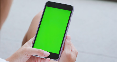 Woman use of smart phone with green screen, chroma key