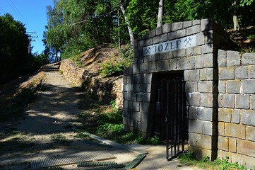 Opened entrance to slovak opal mine Jozef with access path from parking lot visible