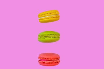 Tasty colorful macaroons on pink background