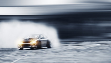 Car drifting, Blurred of image diffusion race drift car with lots of smoke from burning tires on speed track - 218718506