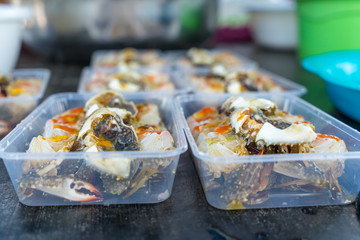 Pickled egg crab in plastic box for sale to tourists