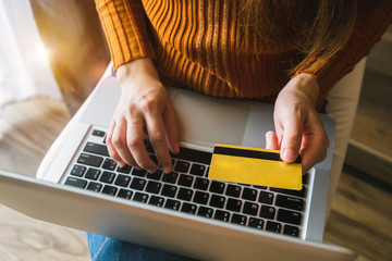 top view of woman hand using smart phone,mobile payments online shopping,omni channel,digital tablet docking keyboard computer in modern office on white desk,virtual interface icons screen