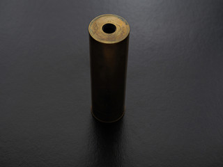 Brass mechanical electronic cigarette on black background