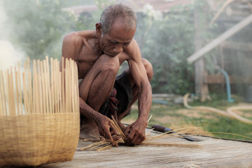 Ole man are weaving basket.