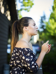 Outdoor atmospheric fashion photo of young beautiful lady