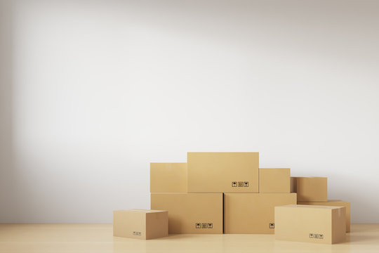 Relocation. A stack of cardboard boxes for moving standing near the white wall. 3d rendering