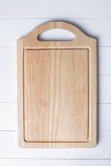 Chopping board on white wooden background