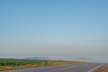 picturesque view of highway on hill with mountains on background
