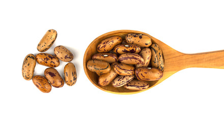 Haricot beans in a wooden spoon  isolated on white background
