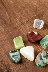 Semiprecious gemstones on a dark wooden background with copyspace