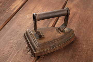 A photo of a vintage iron on a dark background with copyspace