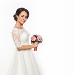 elegant bride on a light background. Beautiful wedding bouquet in a bride hands. free space for...