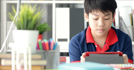 Asian boy watching on tablet computer ,smile face .