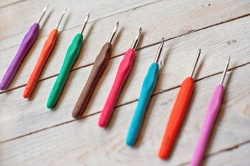 Crochet hooks on a wooden background