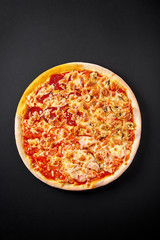 Hot pizza on black background for lunch or dinner crust. Pizza menu.