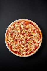 Hot pizza on black background for lunch or dinner crust. Pizza menu.