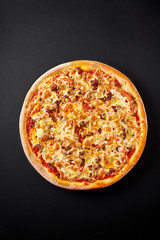 Pizza bolognese. Hot pizza on black background for lunch or dinner crust. Restaurant Menu.