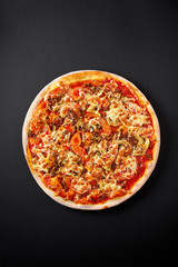 Bolognese pizza. Hot pizza on black background for lunch or dinner crust. Pizza menu