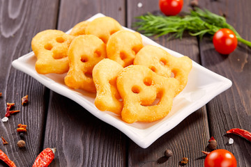Potato fries for kids. Funny faces from potatoes