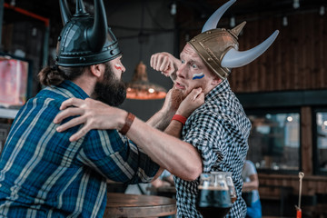 Beating each other. Two bearded men beating each other after watching football match in the pub