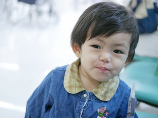 Little Asian baby girl finished taking liquid medicine by herself - allowing babies to take liquid medicine by themselves