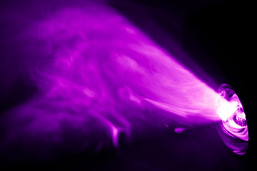 beautiful purple color wide lens projector with light beam for movie and cinema at night . smoke texture spotlight . screening for multimedia . abstract background .