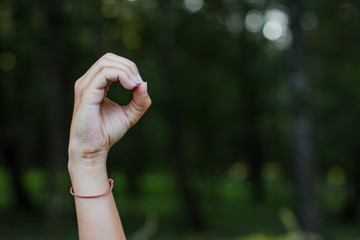 dactyl sign and symbols alphabet concept of human hand and fingers with letters on unfocused blurred dark bokeh natural background environment with empty space for copy or text