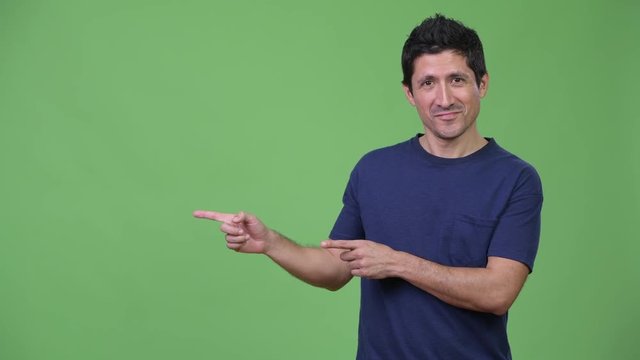 Happy Hispanic man showing something