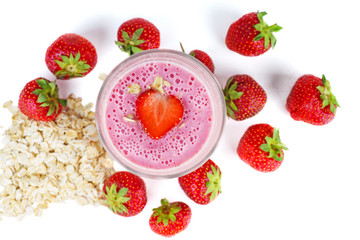 Glass of pink strawberry smoothie with oat flats. Top view