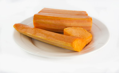Raw pumpkin cut to pieces on white background