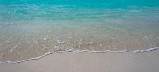 Waves breaking on a sandy beach in the Maldives Islands