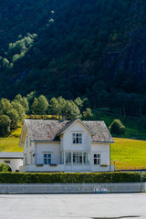 Norway ladscape with wooden whitte wooden house in countryside.