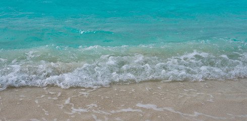 Waves breaking on a sandy beach in the Maldives Islands