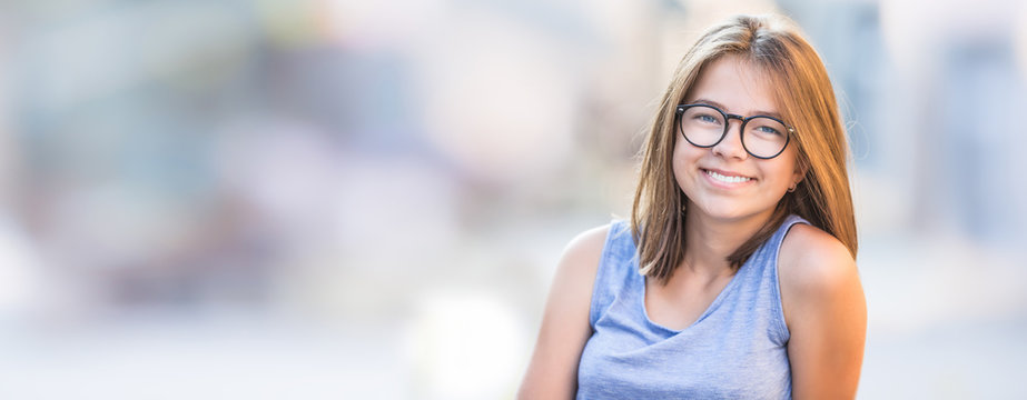 Beautiful young smiling teen girl with glasses.
