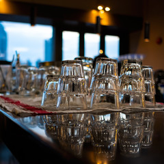 Row of drink glasses on bar countertop selective focus background