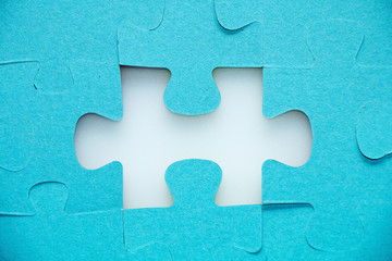 Assembled puzzle on a white background without one element