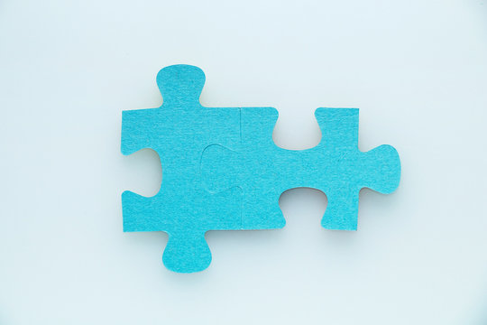 Two pieces of a puzzle piece on a white background.