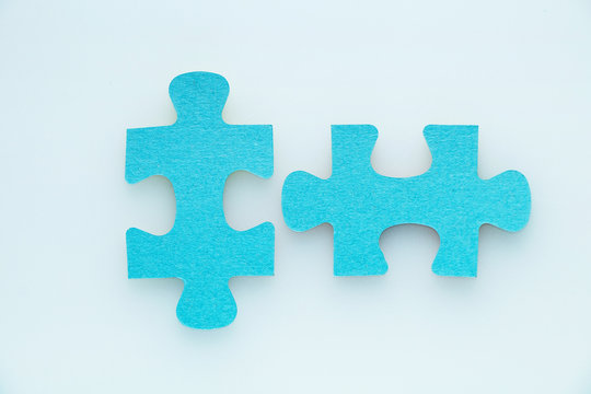 Two pieces of a puzzle piece on a white background.