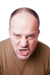 middle aged man with a mad expression on his face shouting                         