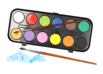 Watercolor pallet and paintbrushes isolated on white, top view