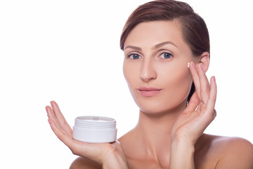 Beauty portrait of a healthy woman, using moisturising cream isolated on white
