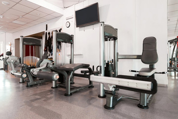 Gym interior with modern equipment. light modern room equipped with different fitness stations. concept of sport and healthy lifestyle
