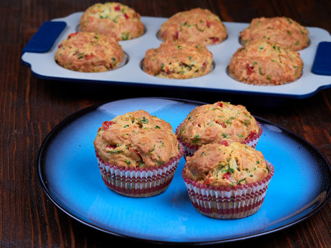 A plate with savory muffins with cheddar, spinach and red peppers