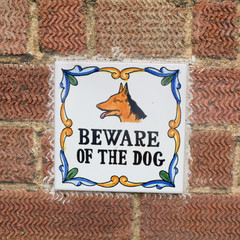 Beware of the dog - handmade ceramic tile fixed to wall outside house