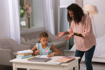 What is this. Angry young woman talking to her daughter while being unhappy with her notes