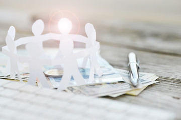 Business angel concept with circle human chain am money on wooden table
