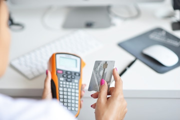 Unrecognizable woman using an POS terminal to pay with credit card
